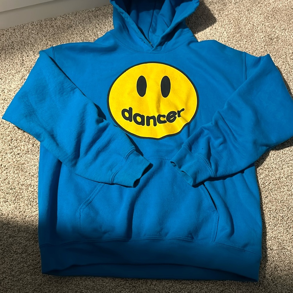 Royal blue hoodie with a yellow smiley face that says dancers on it